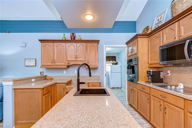 kitchen with tasteful backsplash, light stone counters, a textured ceiling, sink, and stainless steel appliances