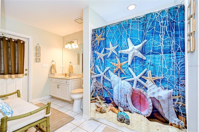 bathroom with vanity, toilet, curtained shower, and tile patterned flooring