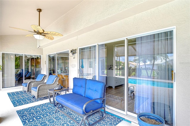 sunroom / solarium with ceiling fan, vaulted ceiling, and a wealth of natural light