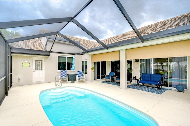 view of swimming pool with a patio and glass enclosure