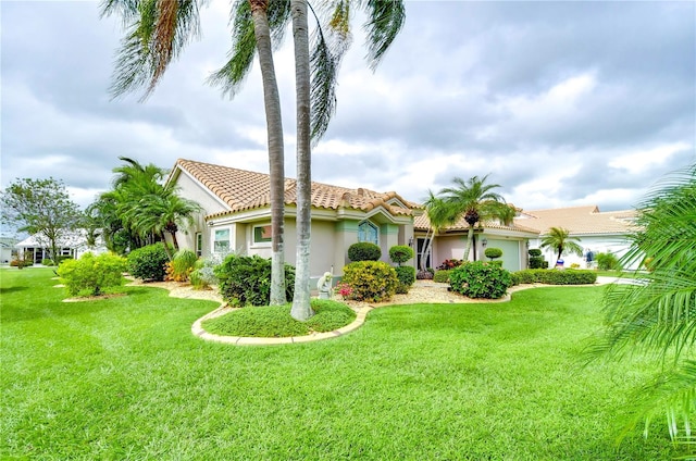 mediterranean / spanish house featuring a front lawn