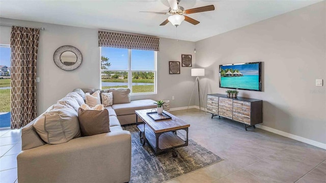 living room with ceiling fan and tile patterned floors