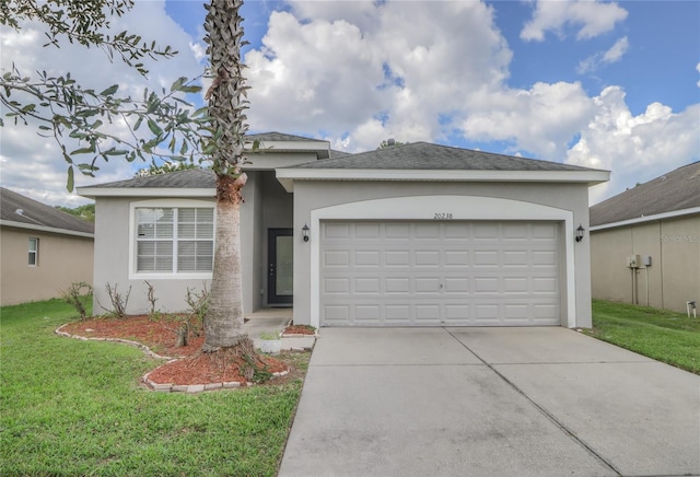 view of front of property with a garage and a front lawn