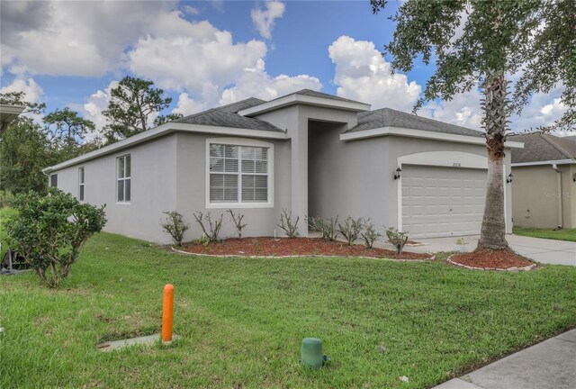 view of front facade featuring a front yard and a garage