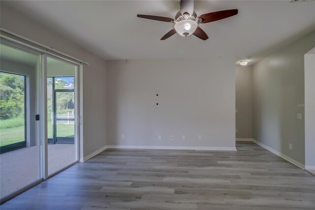 spare room with light wood-type flooring and ceiling fan