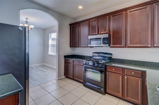 kitchen featuring an inviting chandelier, black appliances, and light tile patterned floors