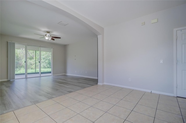 spare room with light hardwood / wood-style flooring and ceiling fan