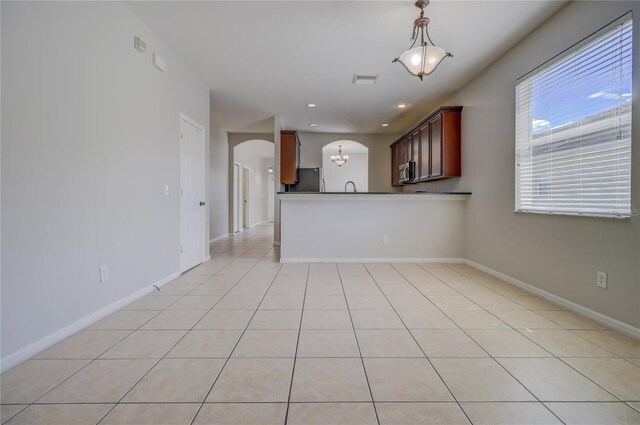 interior space featuring a notable chandelier, sink, and light tile patterned floors