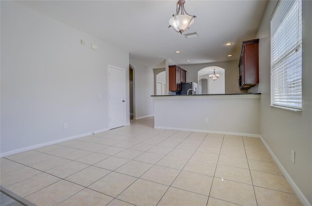 interior space with a chandelier and light tile patterned flooring