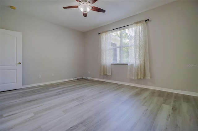 spare room featuring ceiling fan and light wood-type flooring