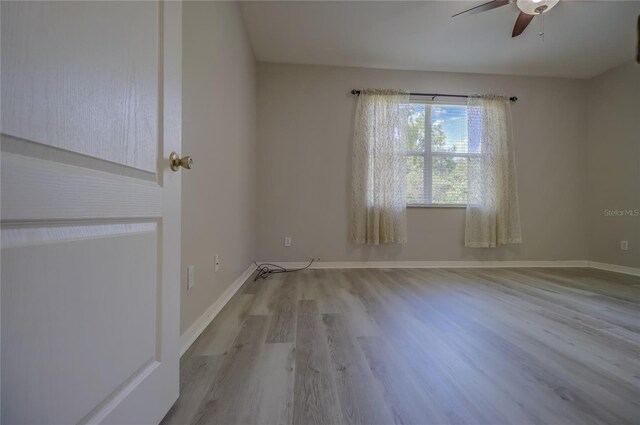 empty room with light hardwood / wood-style flooring and ceiling fan