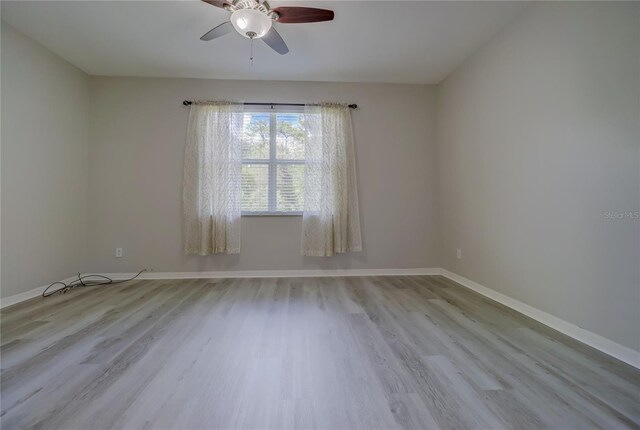 unfurnished room featuring ceiling fan and light wood-type flooring