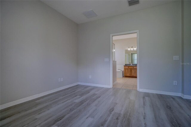 unfurnished room featuring light wood-type flooring