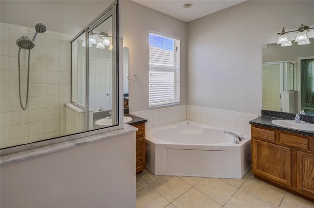 bathroom featuring vanity, plus walk in shower, and tile patterned floors