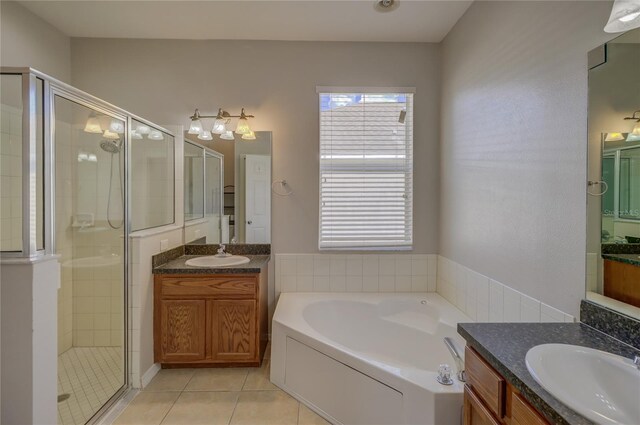 bathroom featuring shower with separate bathtub, tile patterned flooring, and vanity