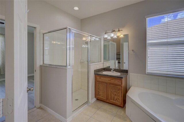 bathroom featuring vanity, shower with separate bathtub, and tile patterned flooring