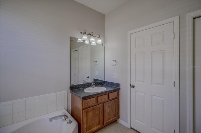 bathroom with tile patterned flooring, vanity, and a bathing tub