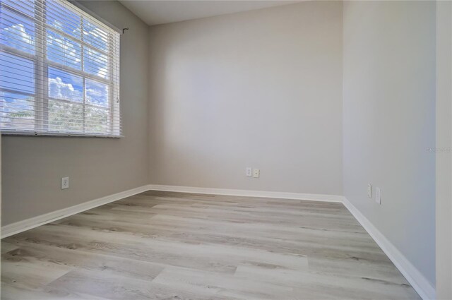 empty room with a healthy amount of sunlight and light hardwood / wood-style flooring