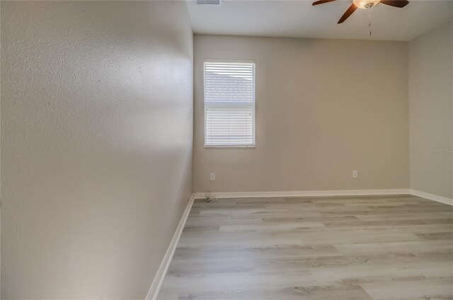 unfurnished room with light wood-type flooring and ceiling fan