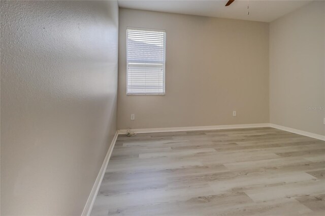 unfurnished room featuring light hardwood / wood-style flooring and ceiling fan