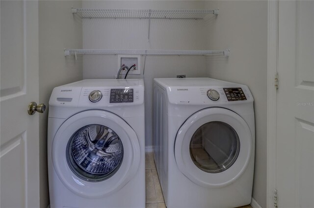 washroom featuring light tile patterned floors and washer and dryer