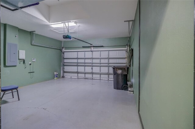 garage featuring a garage door opener and electric panel