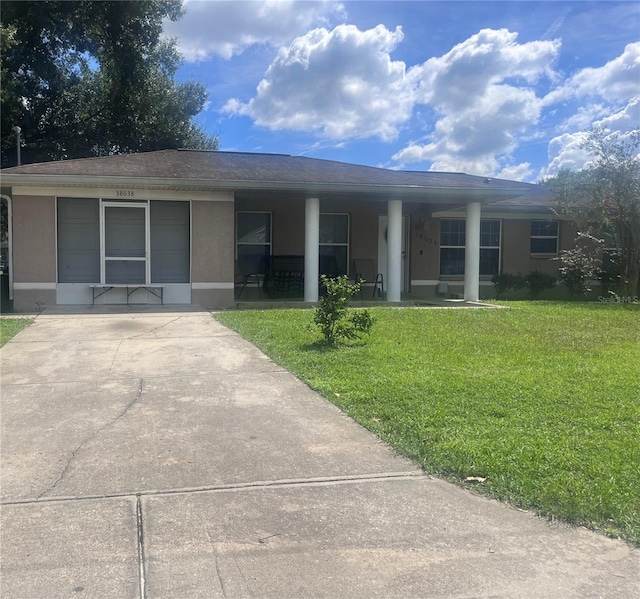 ranch-style home with a front lawn