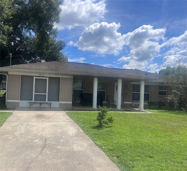 ranch-style home with a front lawn