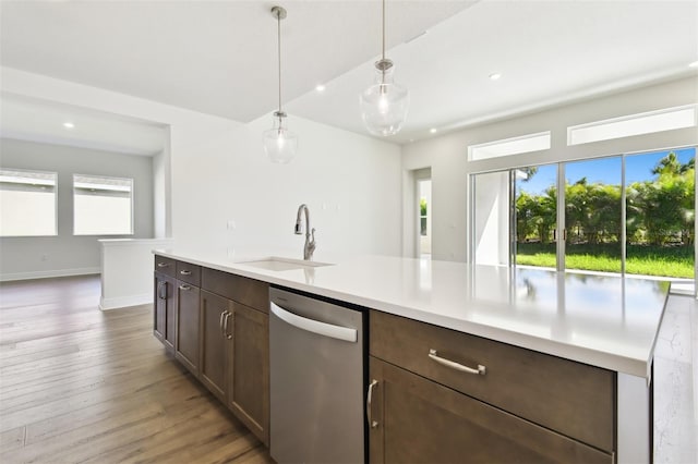 kitchen with dishwasher, sink, hanging light fixtures, light hardwood / wood-style floors, and dark brown cabinets