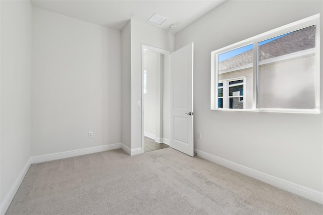 unfurnished bedroom with light colored carpet