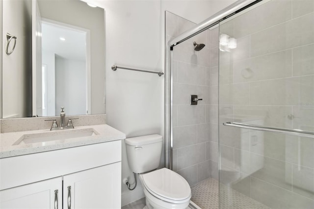 bathroom featuring vanity, toilet, and an enclosed shower