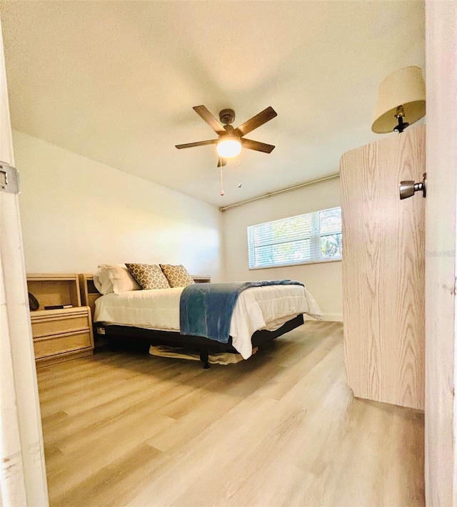 bedroom featuring hardwood / wood-style floors and ceiling fan