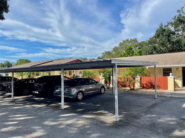 view of parking / parking lot featuring a carport