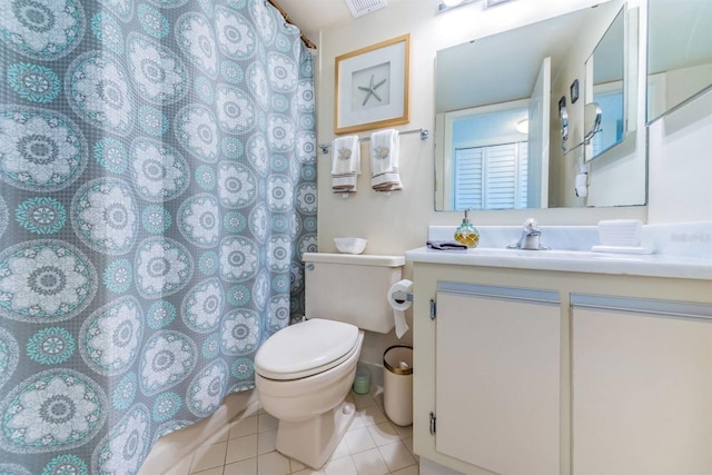 bathroom with a shower with curtain, vanity, toilet, and tile patterned floors