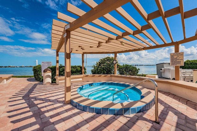 view of pool featuring a pergola, a water view, a patio, and a hot tub