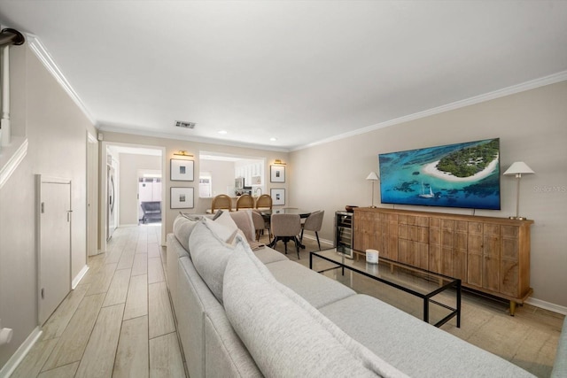 living room featuring light hardwood / wood-style flooring and crown molding