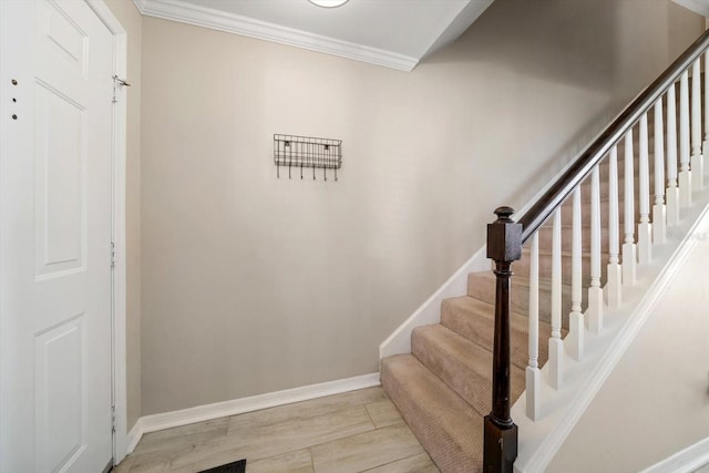 stairs with crown molding and hardwood / wood-style flooring