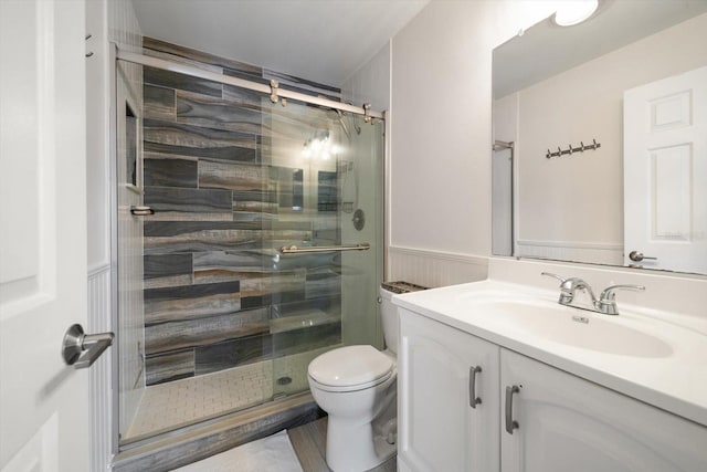 bathroom featuring walk in shower, vanity, and toilet