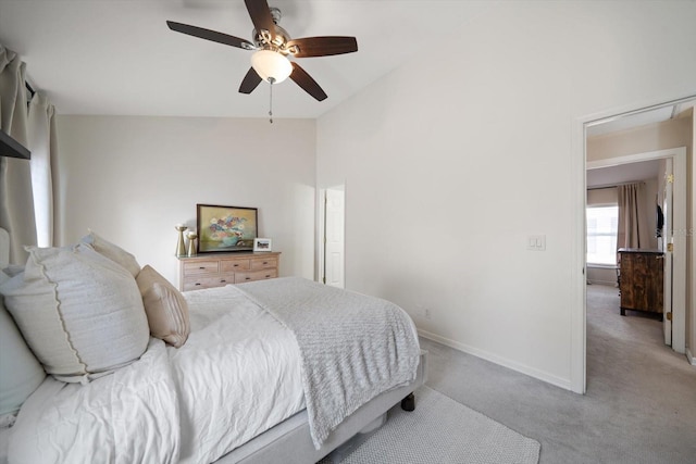 carpeted bedroom featuring lofted ceiling and ceiling fan