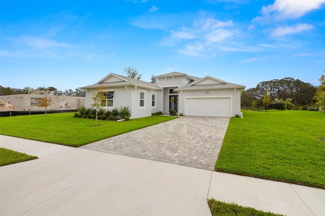 view of front of home with a front lawn and a garage