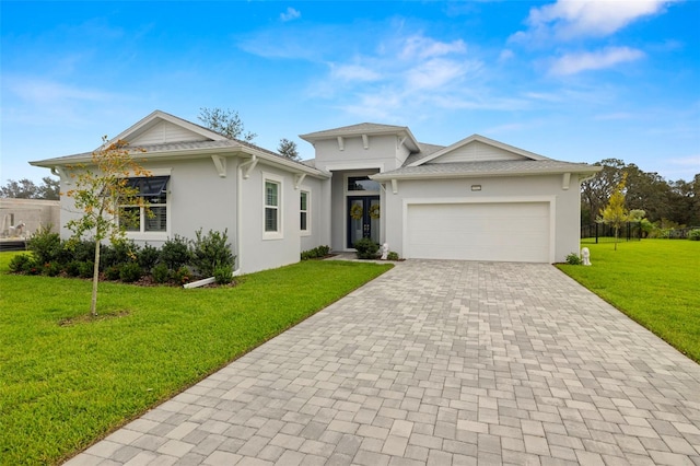 view of front facade with a garage and a front lawn