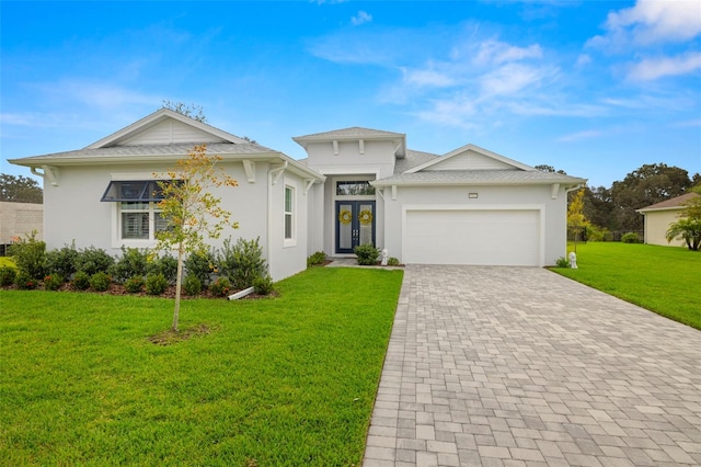 view of front facade featuring an attached garage, decorative driveway, french doors, a front lawn, and stucco siding