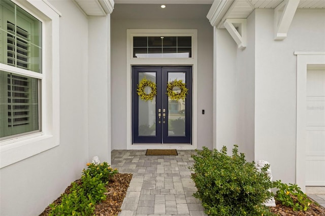 doorway to property with french doors and stucco siding