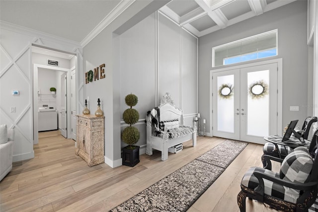 foyer featuring ornamental molding, french doors, light hardwood / wood-style flooring, and coffered ceiling