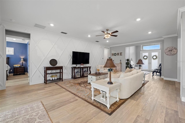 living room featuring light hardwood / wood-style flooring, ceiling fan, and crown molding