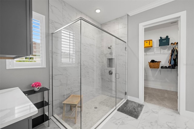 full bath featuring a walk in closet, marble finish floor, crown molding, recessed lighting, and a stall shower