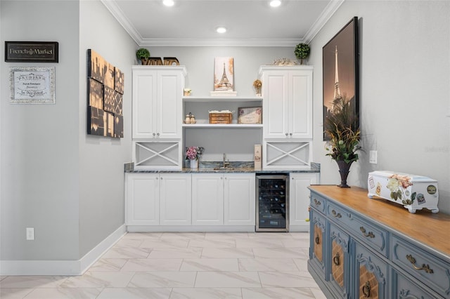 interior space with wine cooler, recessed lighting, baseboards, white cabinets, and ornamental molding