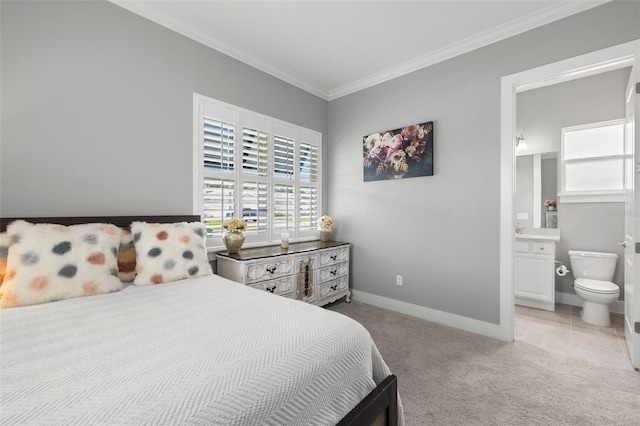 bedroom with carpet floors, baseboards, tile patterned floors, ensuite bath, and crown molding