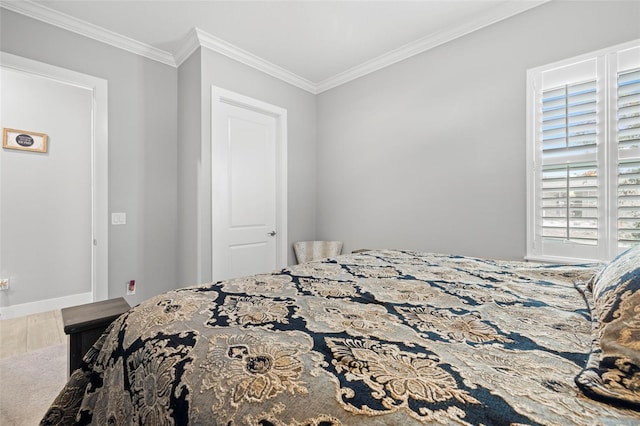 bedroom featuring ornamental molding and hardwood / wood-style flooring