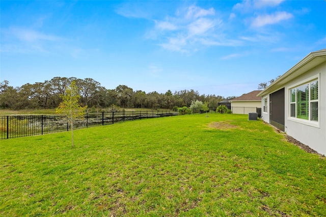 view of yard featuring a rural view and central AC unit